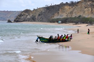 These old wooden boats must be heavy as lead.  Just look at how many men it took to get this boat onto the beach!